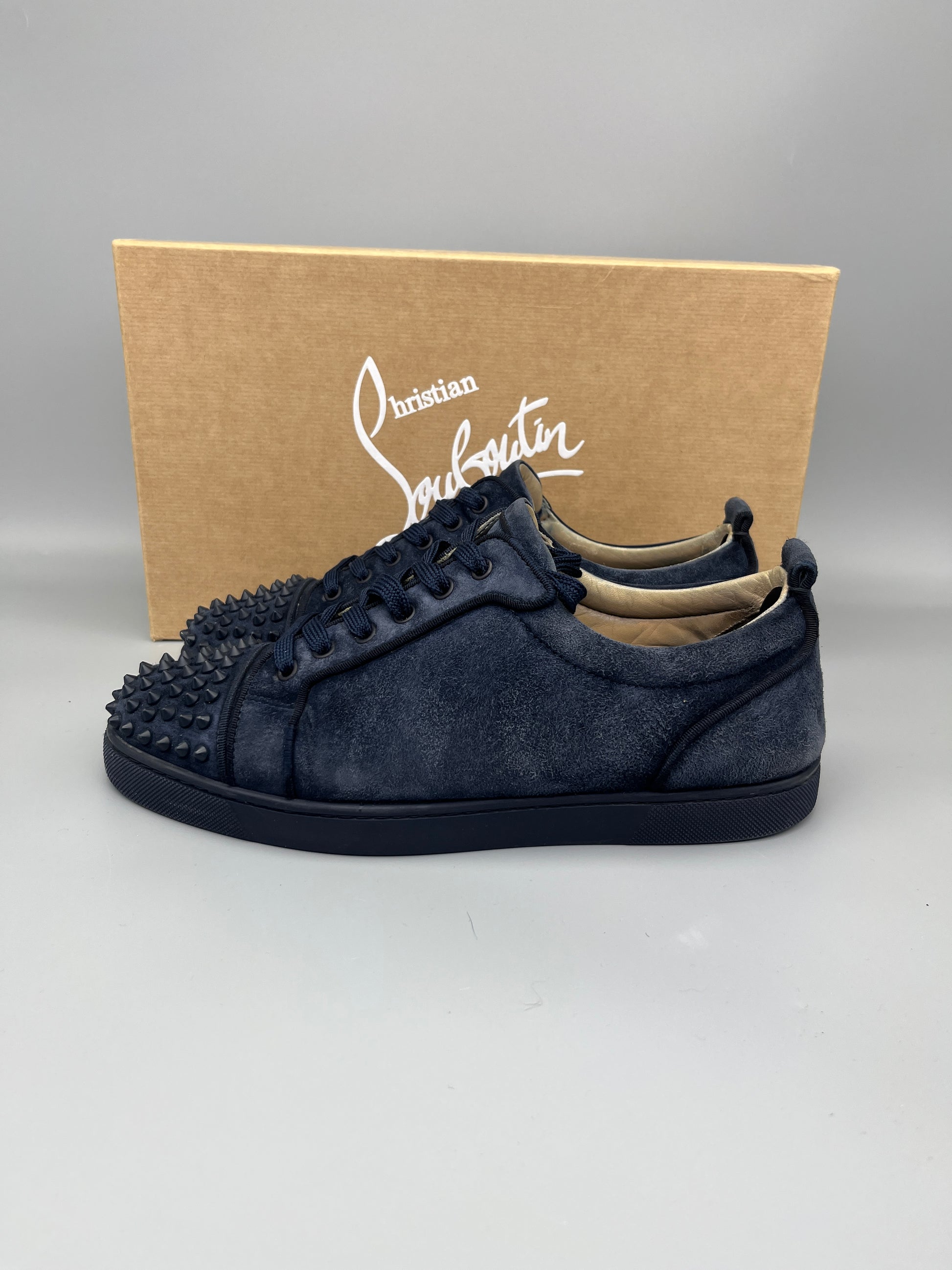 Christian Louboutin Louis Junior Spikes Suede Sneaker in navy – Guaranteed authentic from The Grand Archive.